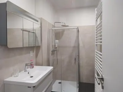 a bathroom with a sink and a shower at Enter City Center in Prague