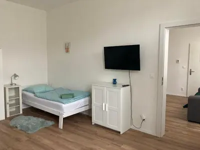 a room with a bed and a flat screen tv at Enter City Center in Prague
