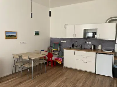 a kitchen with a table and chairs in a room at Enter City Center in Prague