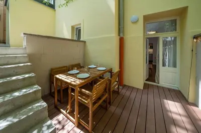 a patio with a table and chairs on a deck at Downtown - Apart Hotel Zborovska in Prague