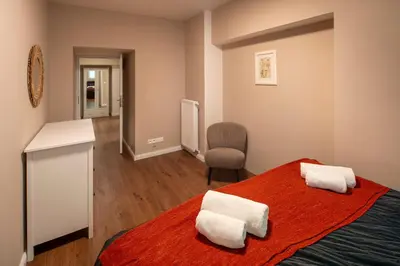 a bedroom with a bed with two towels on it at Downtown - Apart Hotel Zborovska in Prague