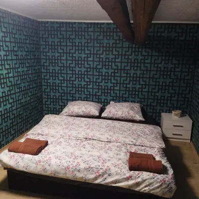 a bedroom with a bed with two pillows on it at Apartmán Roubenka na Dobřeni in Mělník