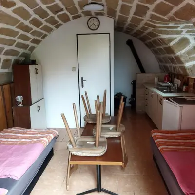 a room with a table and chairs in a kitchen at Apartmán Roubenka na Dobřeni in Mělník