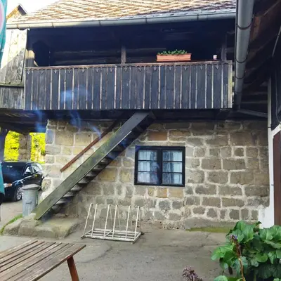 a wooden staircase leading up to a building with a window at Apartmán Roubenka na Dobřeni in Mělník