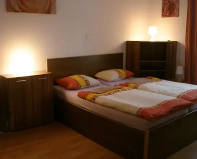 a bedroom with a bed with two pillows on it at EASY JOURNEY Apartments in Prague