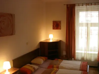 a bedroom with a bed with two lamps and a window at EASY JOURNEY Apartments in Prague