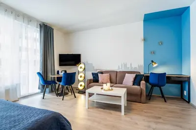 a room with a bed and a couch and a table at AuriApartments Libeň nový byt 1kk s garáží in Prague