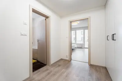 an empty room with a door and a mirror at AuriApartments Libeň nový byt 1kk s garáží in Prague