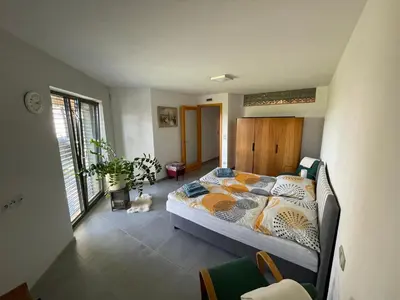 a bedroom with a bed and a dog laying on the floor at Ubytování U Vinice in Mělník