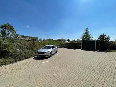 a silver car parked in a parking lot at Ubytování U Vinice in Mělník