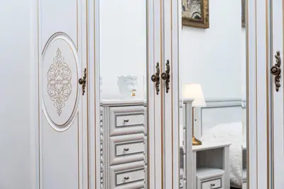 a white cabinet with a mirror in a bedroom at Magnificent King Suite in Prague