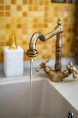 a sink with water coming out of a faucet at Magnificent King Suite in Prague