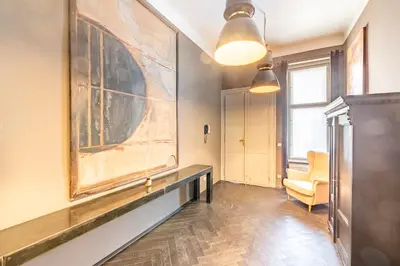 a living room with a large painting on the wall at Masná - Old Town Grand Residence in Prague