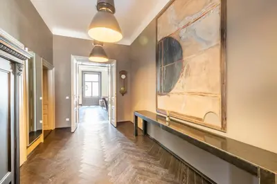 a hallway with a large painting on the wall at Masná - Old Town Grand Residence in Prague