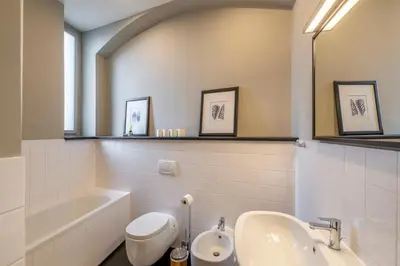 a bathroom with a sink and a toilet and a tub at Masná - Old Town Grand Residence in Prague