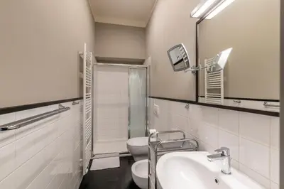 a bathroom with a toilet and a sink and a mirror at Masná - Old Town Grand Residence in Prague