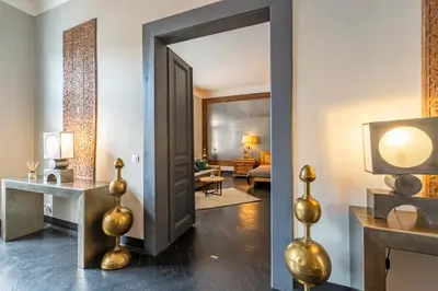 a hallway with a door leading to a living room at Masná - Old Town Grand Residence in Prague