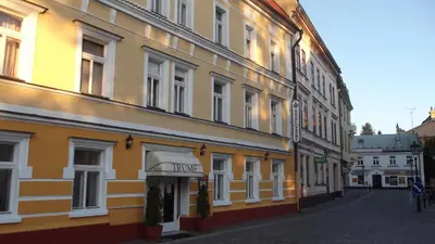 a yellow building with a sign for a hotel at Hotel Trumf in Mladá Boleslav