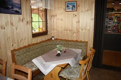 a table and chairs in a room with wooden walls at Letní rekreační středisko Schiffler Miroslav in Samopše