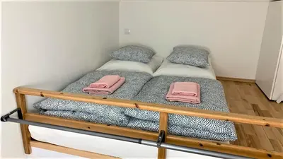 a bunk bed with pink towels on top of it at Side Street Apartments in Prague