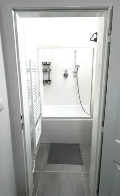 a bathroom with a shower with a glass door at Side Street Apartments in Prague