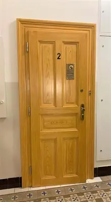a wooden door with the number on it at Side Street Apartments in Prague