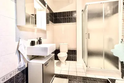 a bathroom with a sink toilet and a shower at Apartmán u Berounky in Beroun