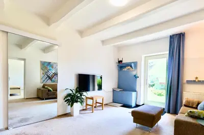 a living room with a couch and a tv at Apartmán u Berounky in Beroun