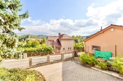 an exterior view of a house with a fence at Apartmán u Berounky in Beroun
