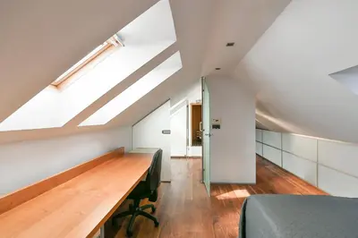 a bedroom with a desk and a bed in a attic at LUXURY CENTRAL PENTHOUSE WITH SAUNA, TERRACE, 250m2, 5BDRM, 3BTHRM in Prague