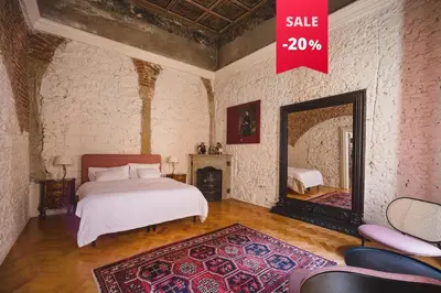 a bedroom with a bed and a large mirror at King Charles Apartment in Prague