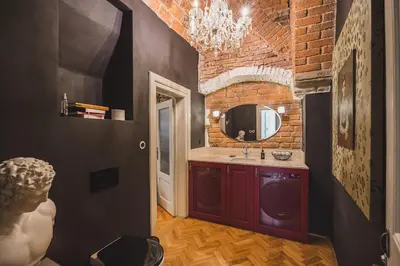 a bathroom with a sink and a brick wall at King Charles Apartment in Prague