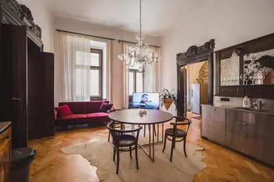 a living room with a table and some chairs at King Charles Apartment in Prague