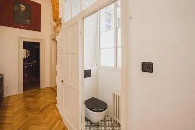 a bathroom with a toilet in the corner of a room at King Charles Apartment in Prague
