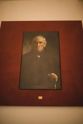 a portrait of a man in a painting on a wall at King Charles Apartment in Prague
