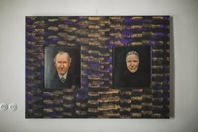 a wall with two portraits of a man on it at King Charles Apartment in Prague