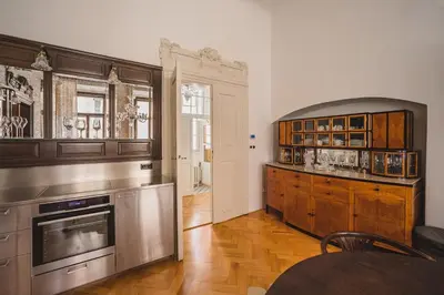 a kitchen with stainless steel appliances and wooden cabinets at King Charles Apartment in Prague