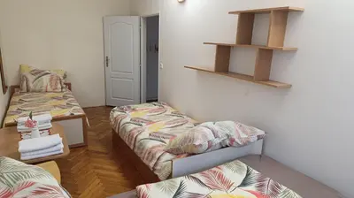 a room with two beds and shelves on the wall at Apartment Dream in Prague
