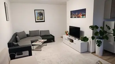 a living room with a couch and a tv at Apartment Dream in Prague