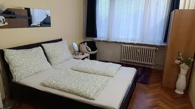 a bedroom with a bed with white sheets and pillows at Apartment Dream in Prague