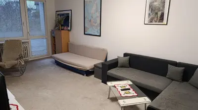 a living room with a couch and a chair at Apartment Dream in Prague