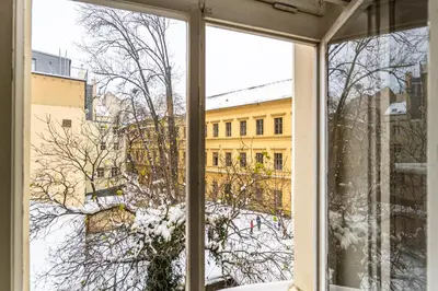 a window with a view of a snow covered yard at Wenceslas Square 2 Bedroom Apartment in Prague