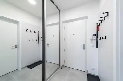 a row of doors in a room with a mirror at Apartment Michelská in Prague