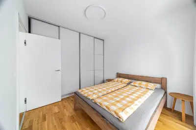 a bedroom with a bed with white walls at Apartment Michelská in Prague