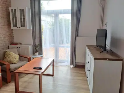 a living room with a tv and a couch and a table at Apartments Old Town in Brandýs nad Labem-Stará Boleslav