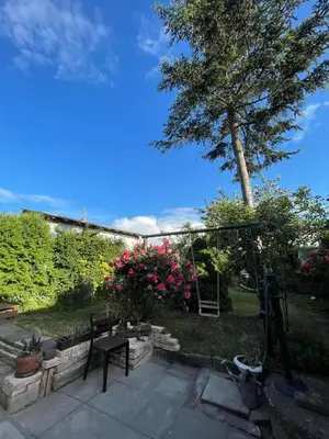 a patio with a tree and some pink flowers at Apartments Old Town in Brandýs nad Labem-Stará Boleslav