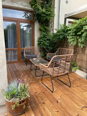 three chairs sitting on a wooden deck with plants at Apartments Old Town in Brandýs nad Labem-Stará Boleslav