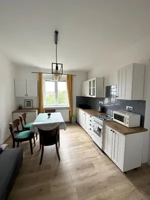 a kitchen with a table and chairs and a dining room at Apartments Old Town in Brandýs nad Labem-Stará Boleslav