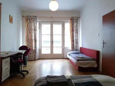 a bedroom with a bed and a desk and a window at Best Location in Prague - Old Town in Prague