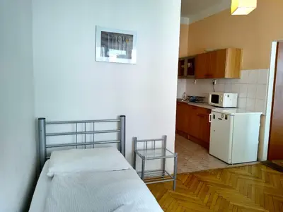 a small kitchen with a bed and a refrigerator at Best Location in Prague - Old Town in Prague